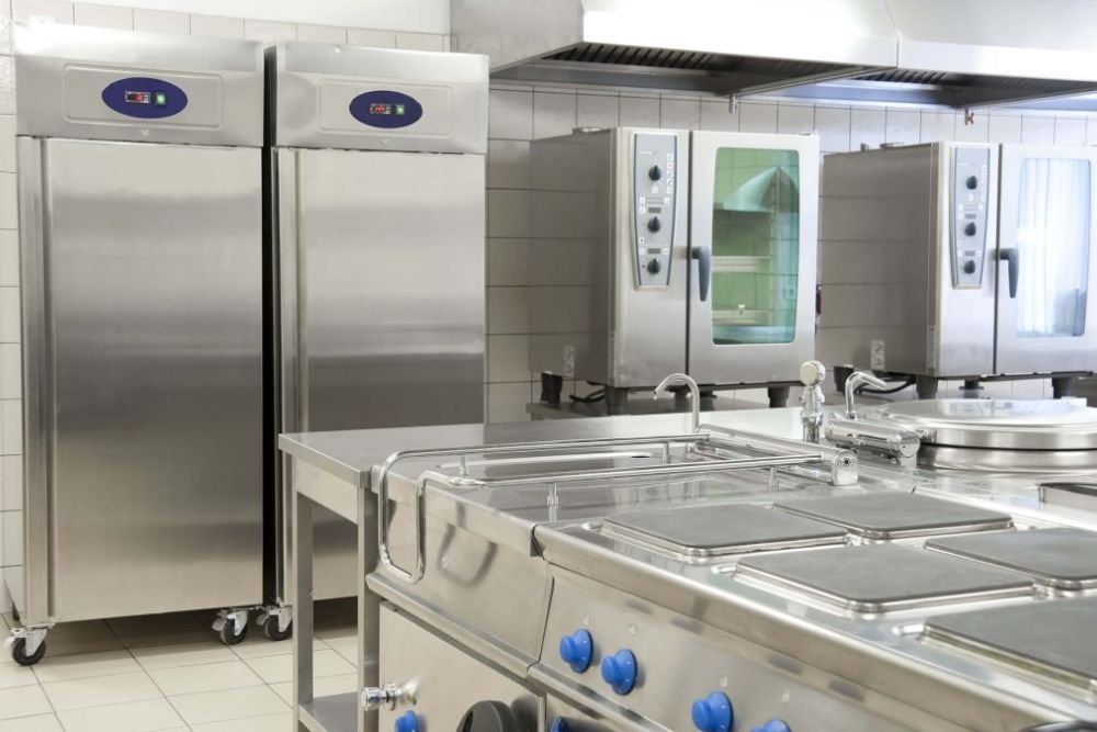 A well-equipped commercial kitchen showcasing stainless steel appliances, linked to a repair service in Long Beach, CA.