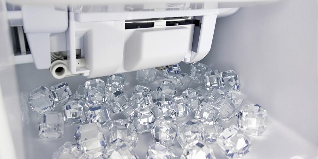 A close-up view of a freezer filled with clear ice cubes, showcasing their crystalline structure and frosty appearance.