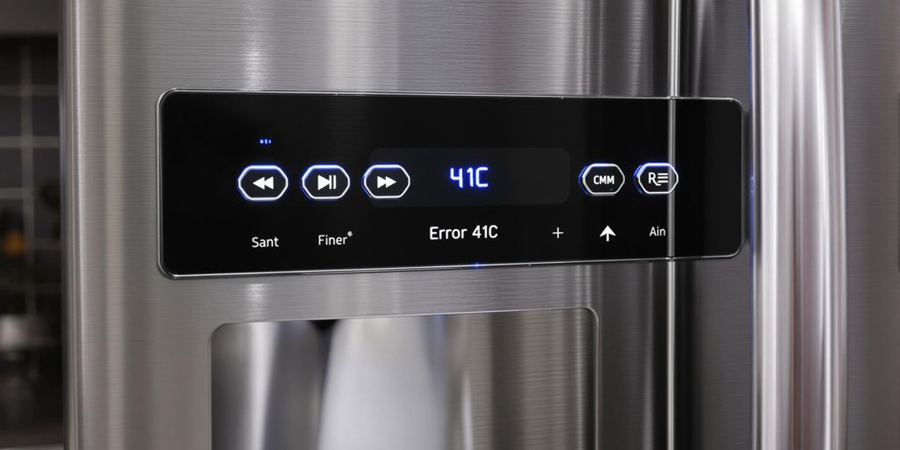 Close-up of a stainless steel refrigerator showcasing its sleek electronic control panel and modern design features.