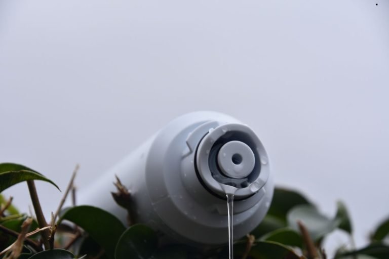 A white water filter placed on a bush, illustrating a moment of tranquility in a natural environmen